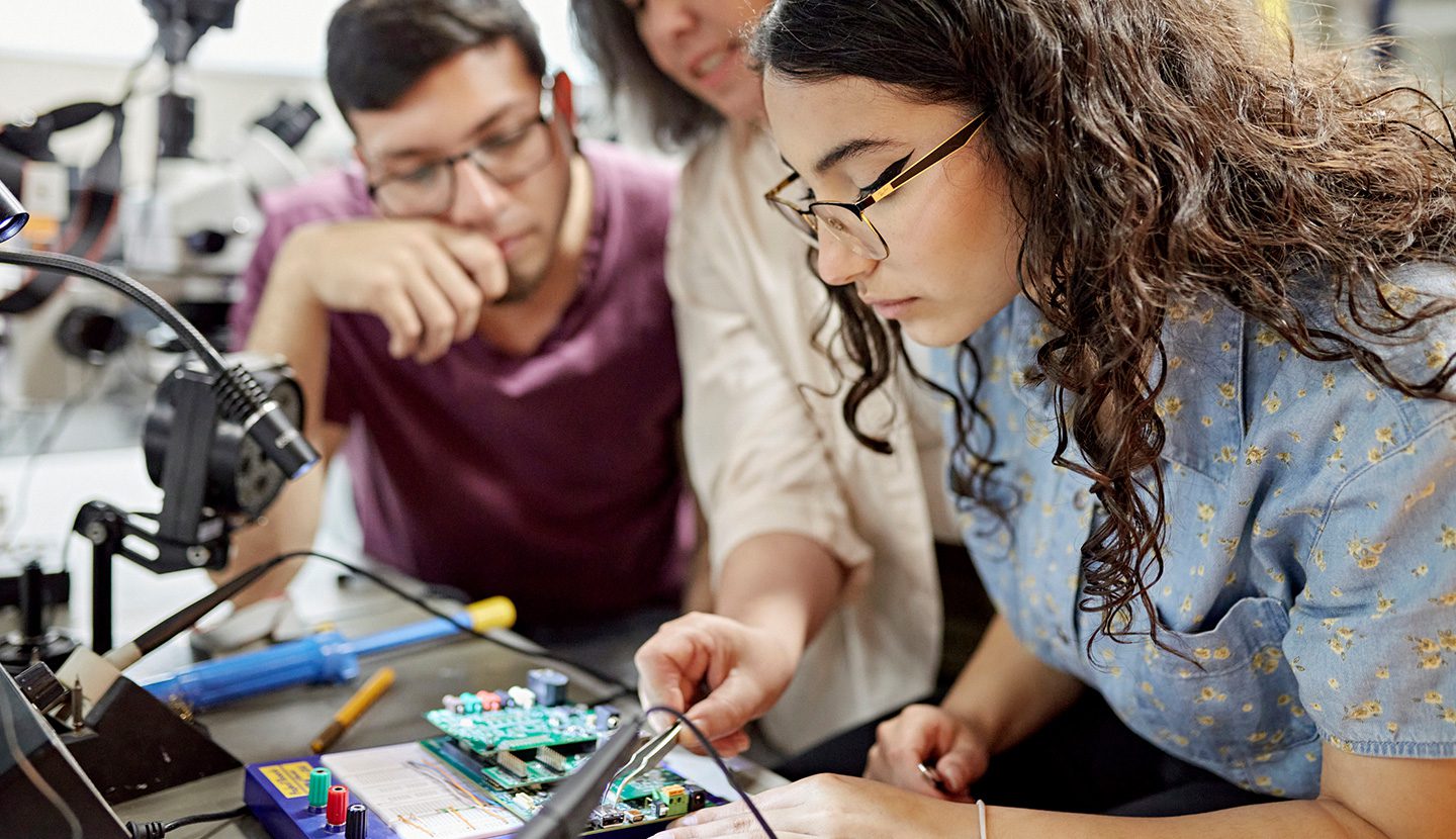 Group of students working on circuit board